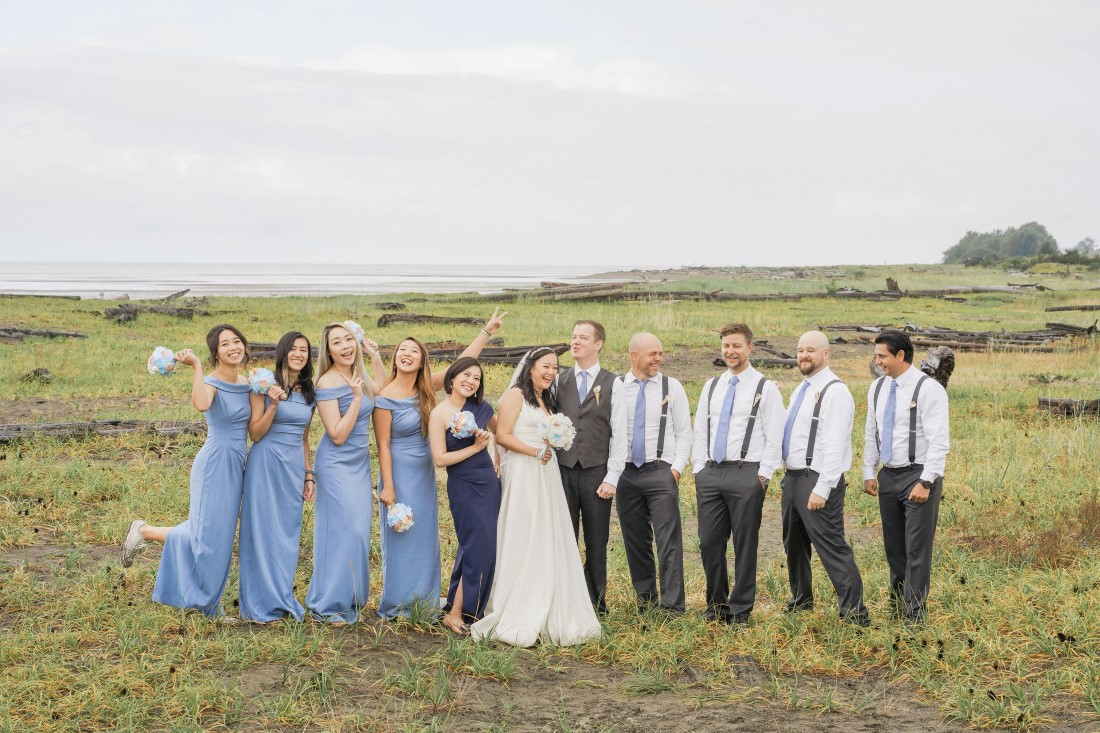 Wedding Party wearing blue along Iona Beach in Vancouver