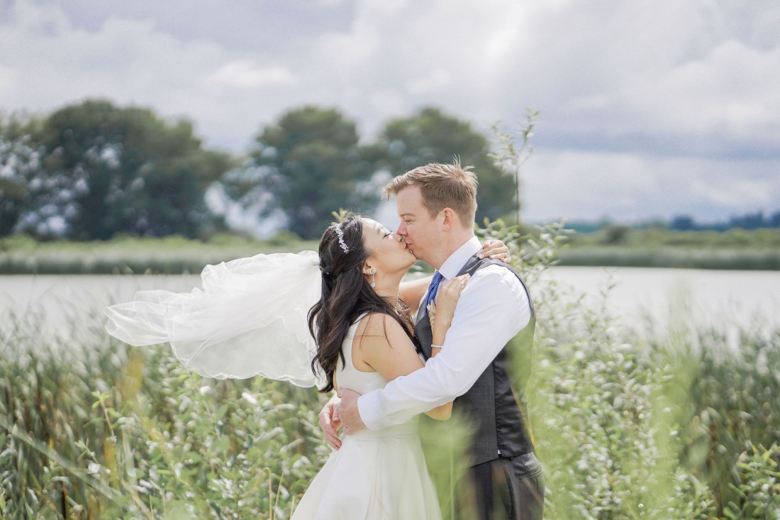 Newlyweds kiss along Iona Beach in Vancouver 