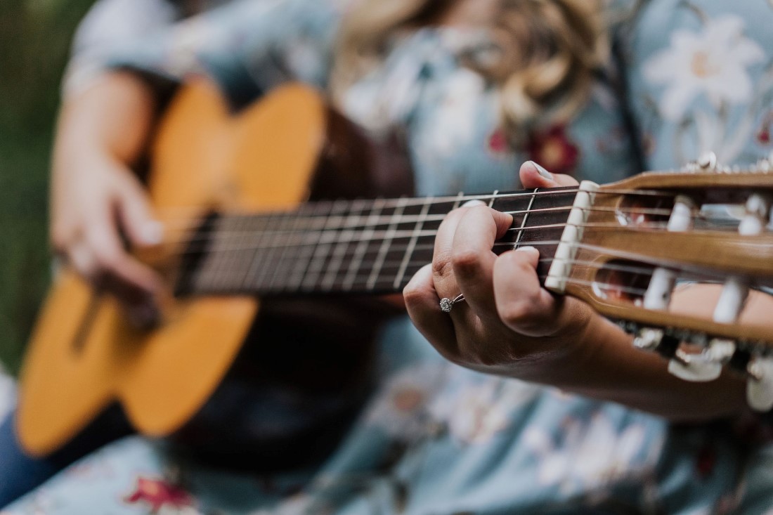 Hand playing guitar by Miko Weddings