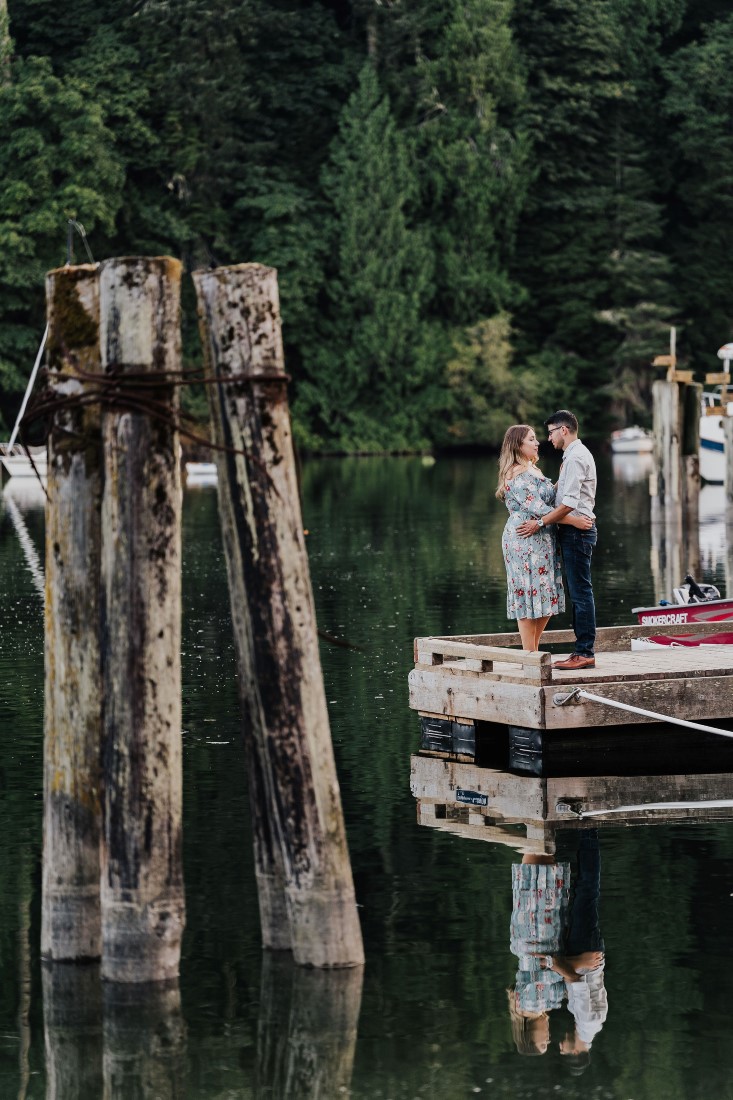 Romantic Couple embrace at the end of a pier on Vancouver Island