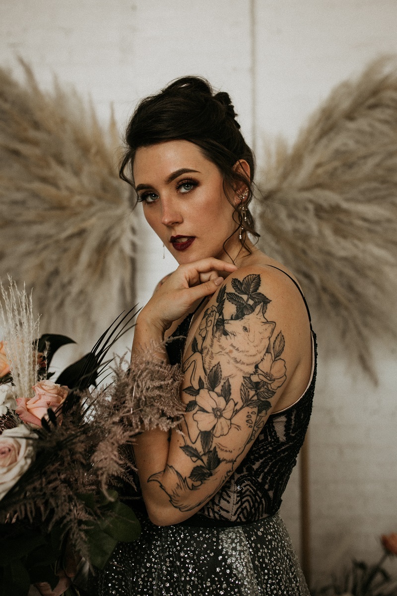 Bride with tattooed arms by Secret Waters Photography