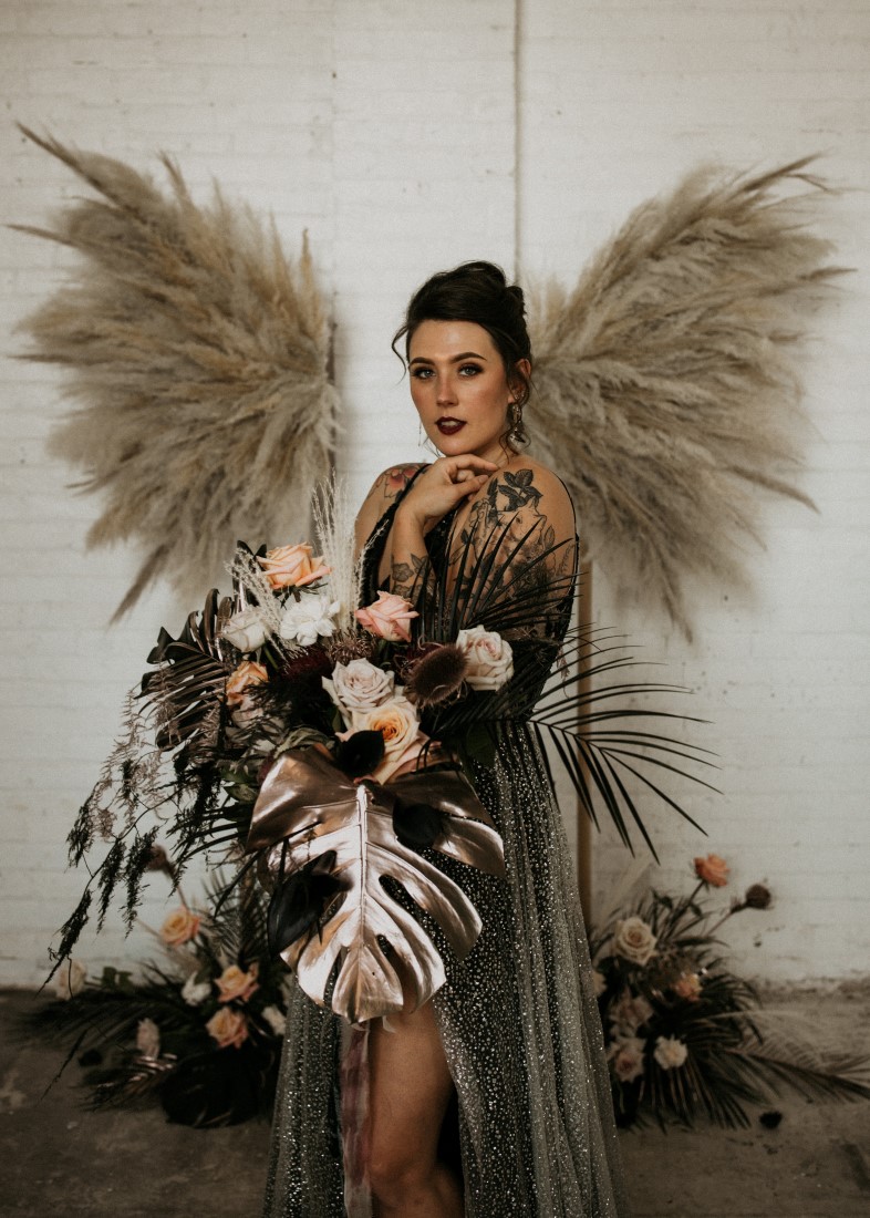 Bride holding bouquet with Pampas grass wings