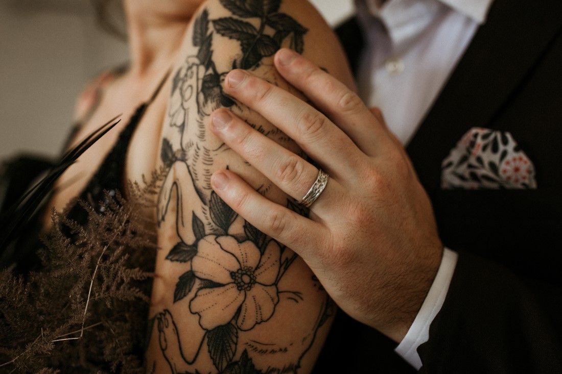 Industrial Chic bride with tattoos on her arm and ring by Emma Glover