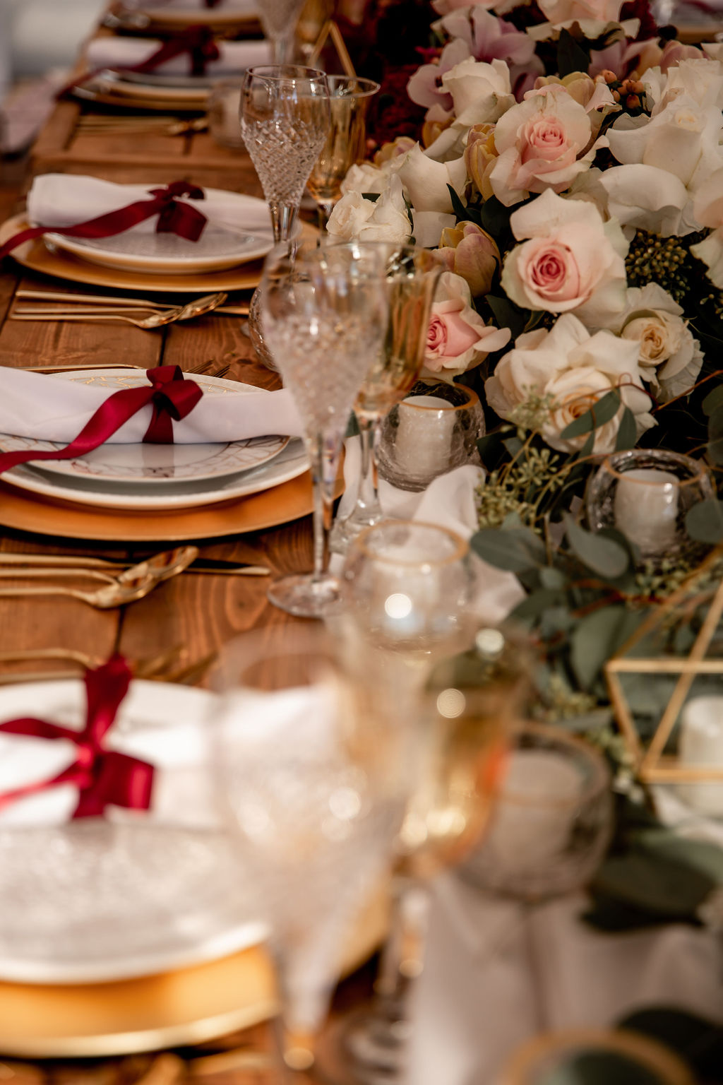 Gold and white plates with burgundy  napkins along pink orchids by Ellssi Designs Vancouver