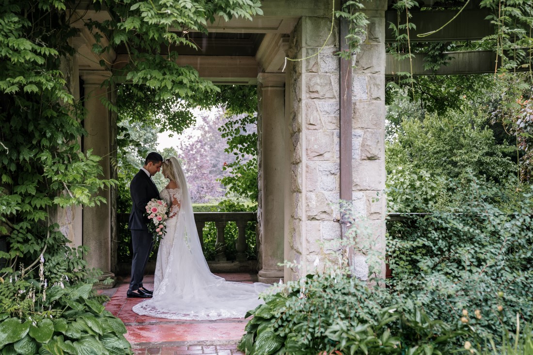 Newlyweds in the ivy gardens of Hatley Castle Vancouver Island