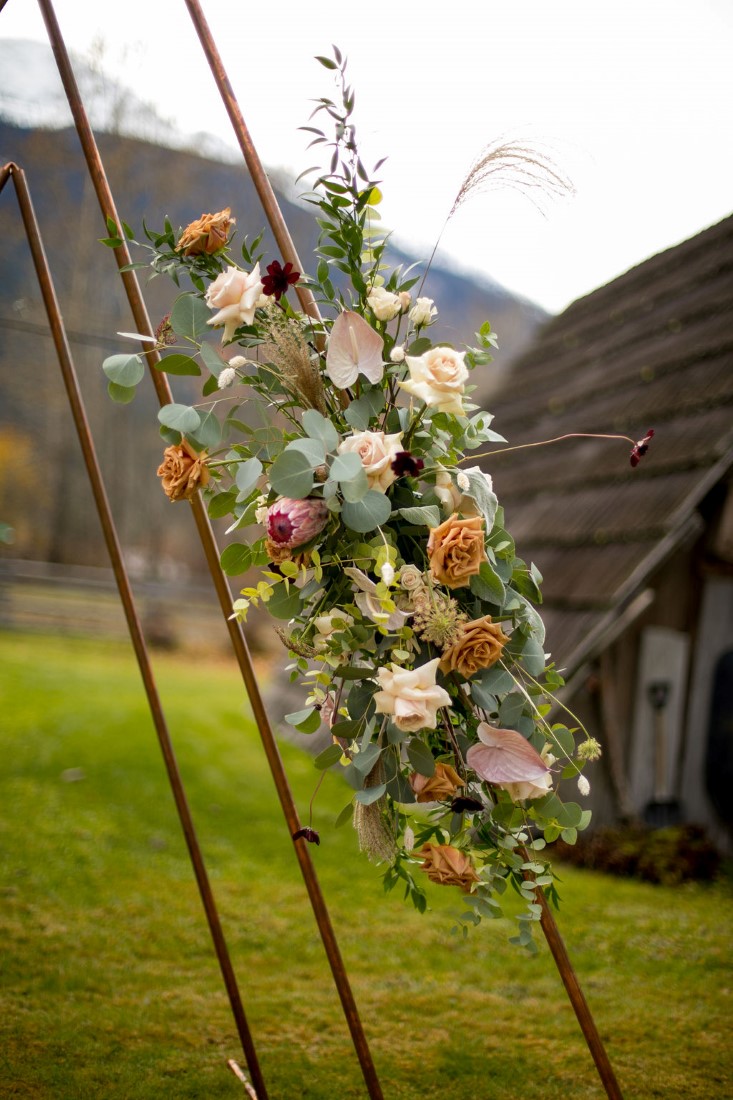 Floral Design on ceremony arch by Within Us Flowers