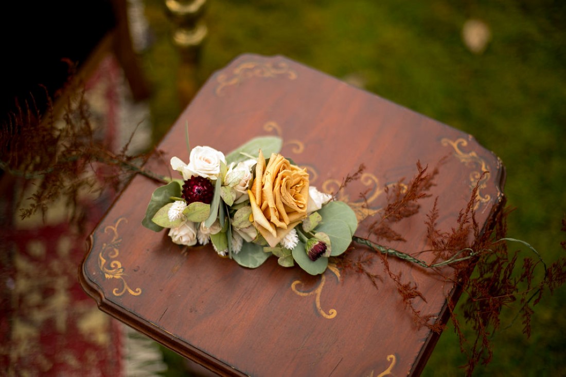 Floral on small wooden table of wedding lounge furniture