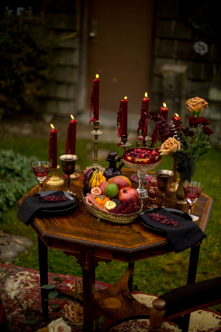 Breathtaking Wedding Beauty table filled with burgundy tall candles and bright roses