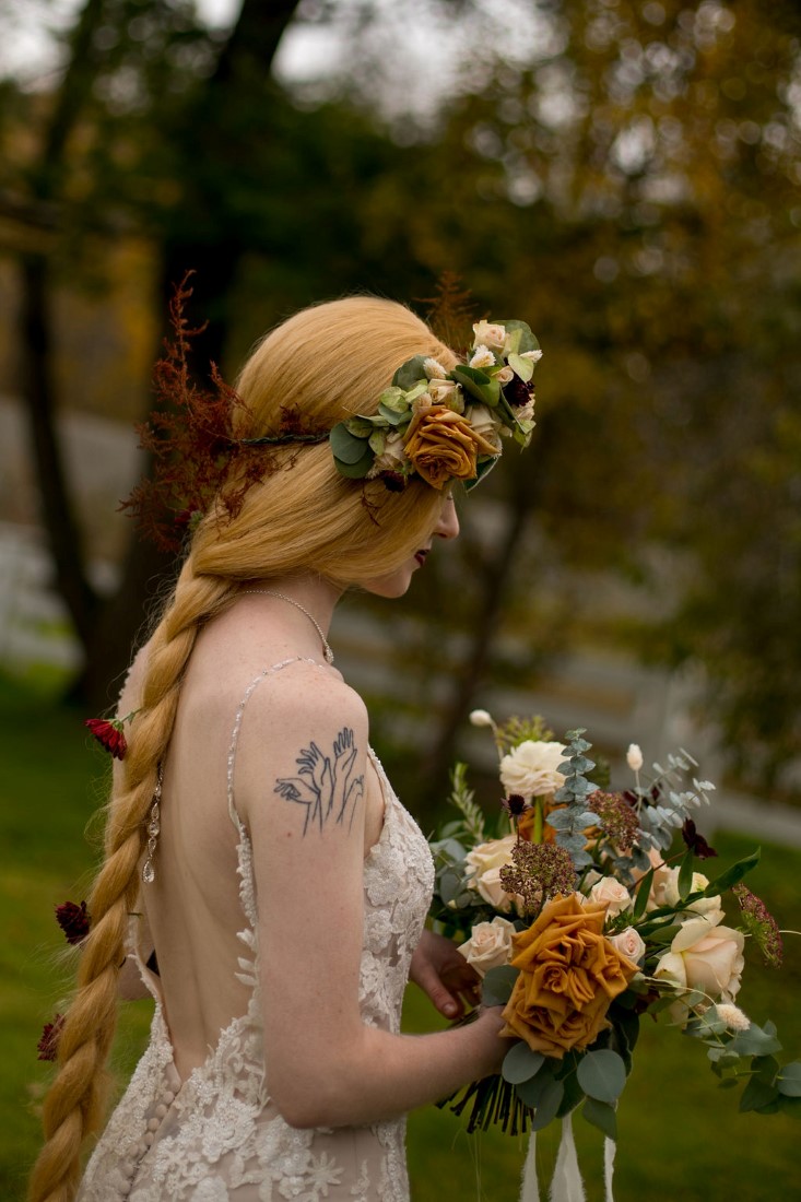 Bride wearing braid wig and floral crown by Meghan Andrews Photography