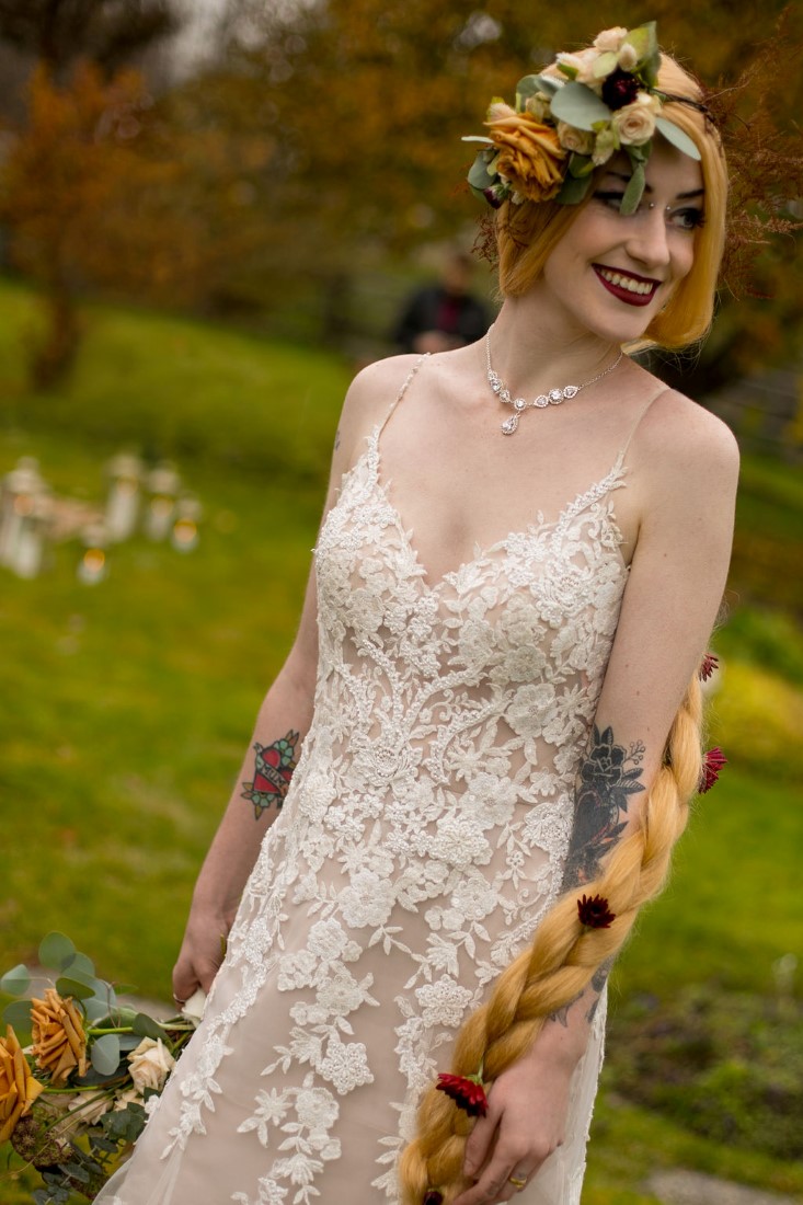 Bride in white lace gown and long blonde braid with floral crown by Isabelle's Bridal Vancouver