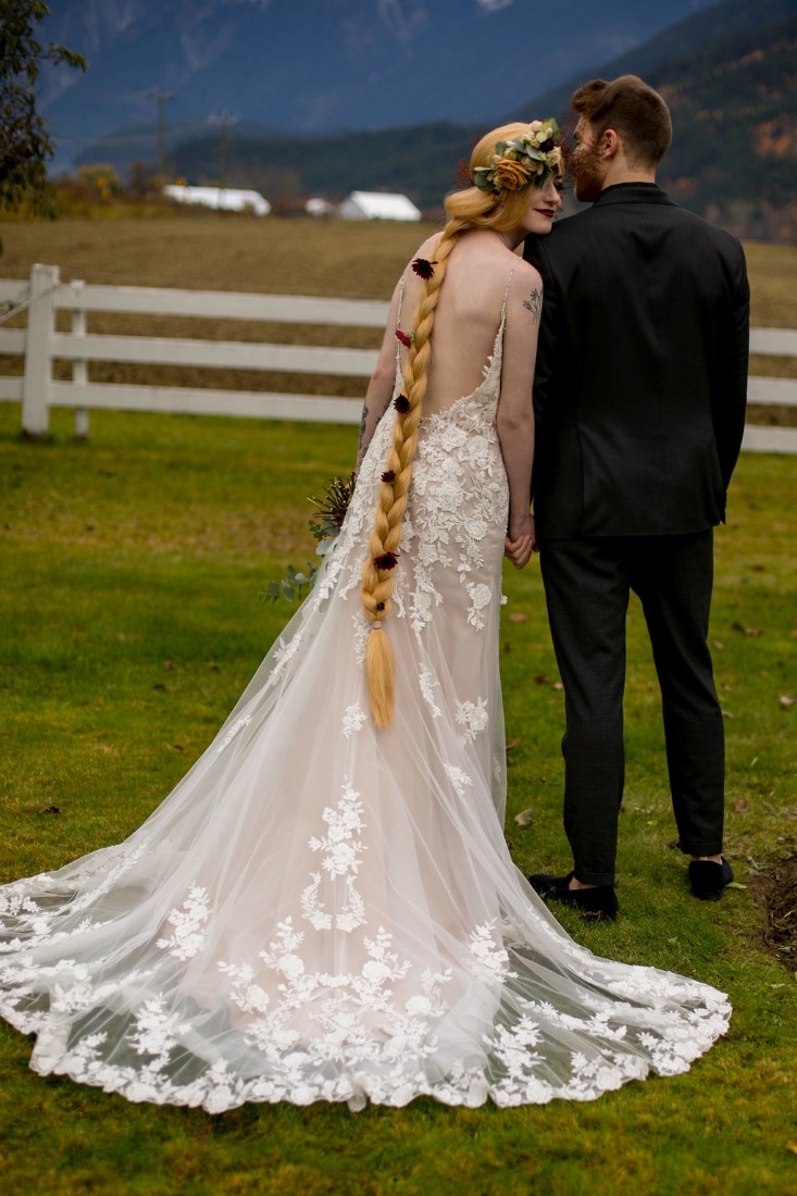 Breathtaking Wedding Beauty couple shows off blonde braid and wedding gown train of lace