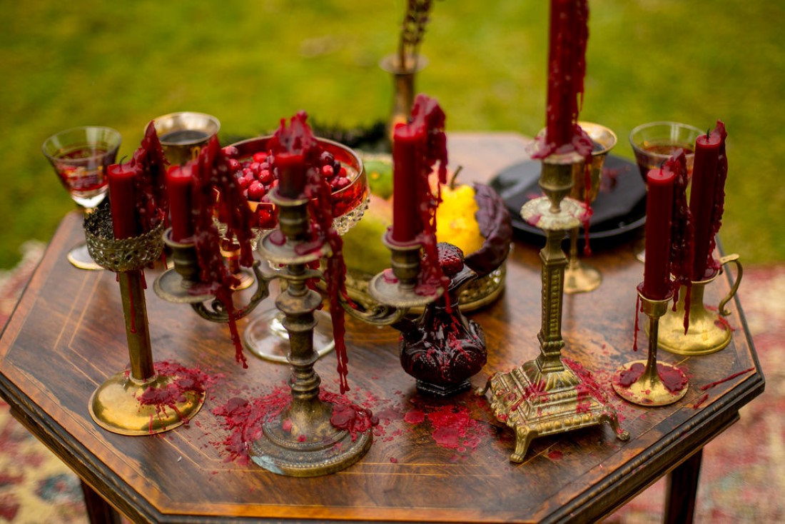 Burgundy and orange roses with tall candlesticks wedding decor