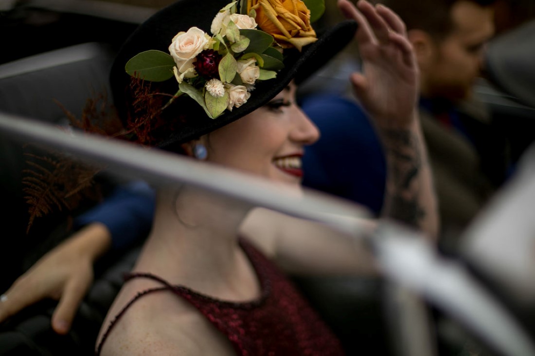 Bride wears black hat covered in floral by Isabelle's Bridal Vancouver