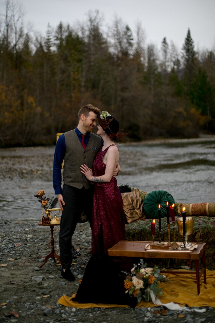 Newlyweds sit on settee in the middle of a road in Pemberton