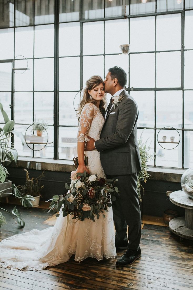 Newlyweds in front of window panes and snow