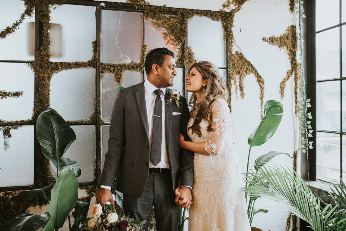 Newlyweds smile at each other 