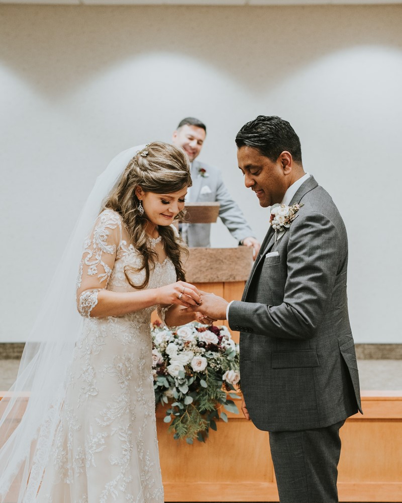 Bride and groom exchange rings at ceremony