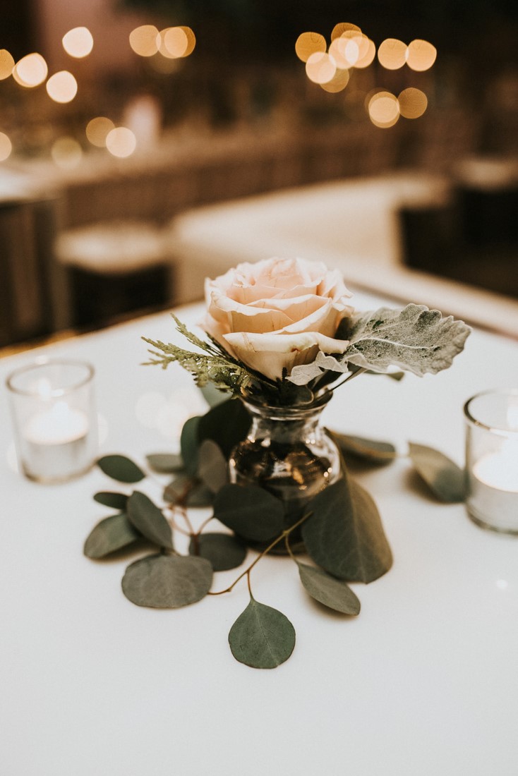 Blush Pink Rose surrounded by eucalyptus on wedding table