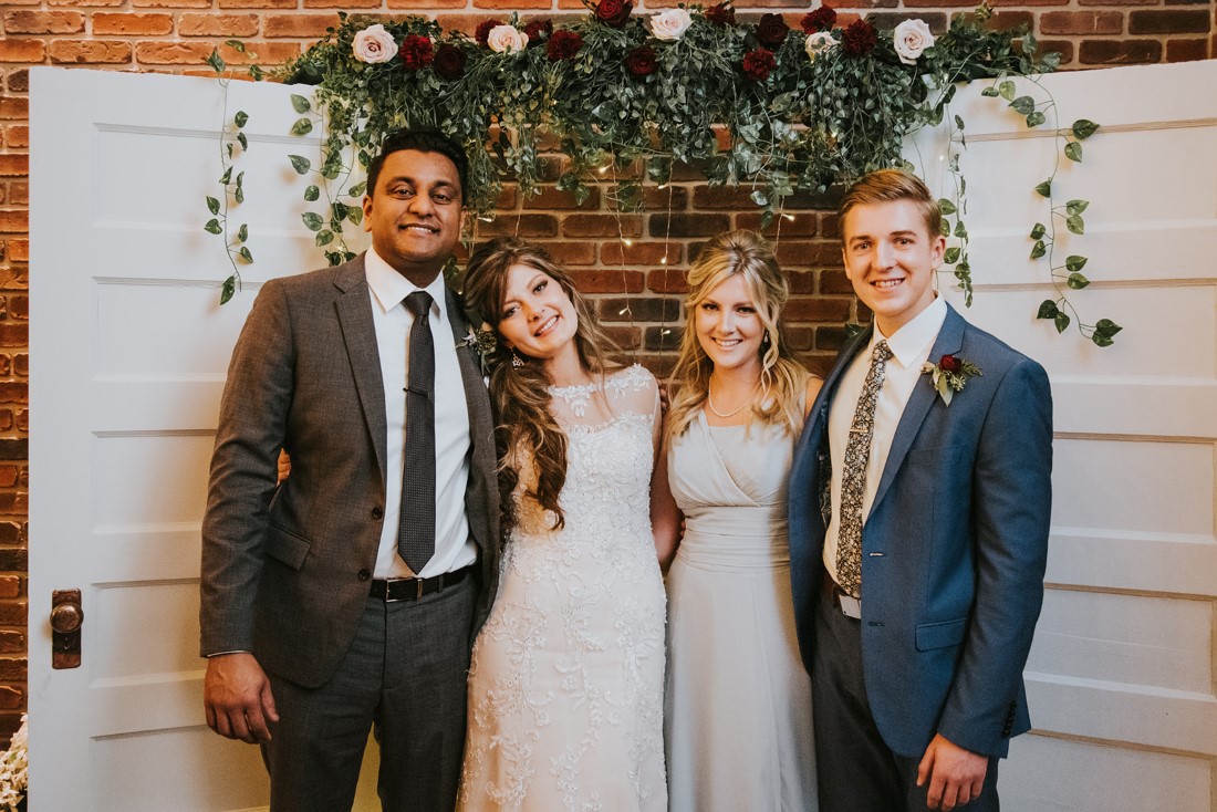 Photo Booth made of white antique doors with floral cascading above 