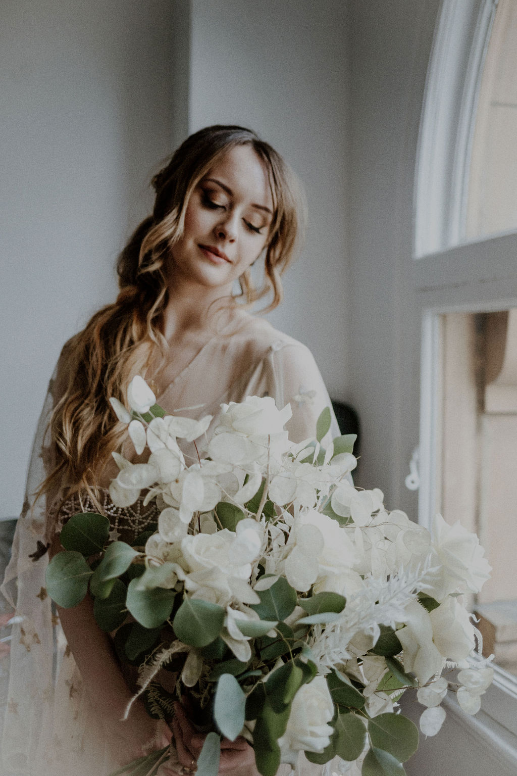 Bride holds bouquet of large white lillies by Van Simone Floral Vancouver