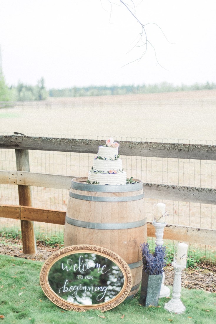 Wedding Cake on Barrel beside country fence