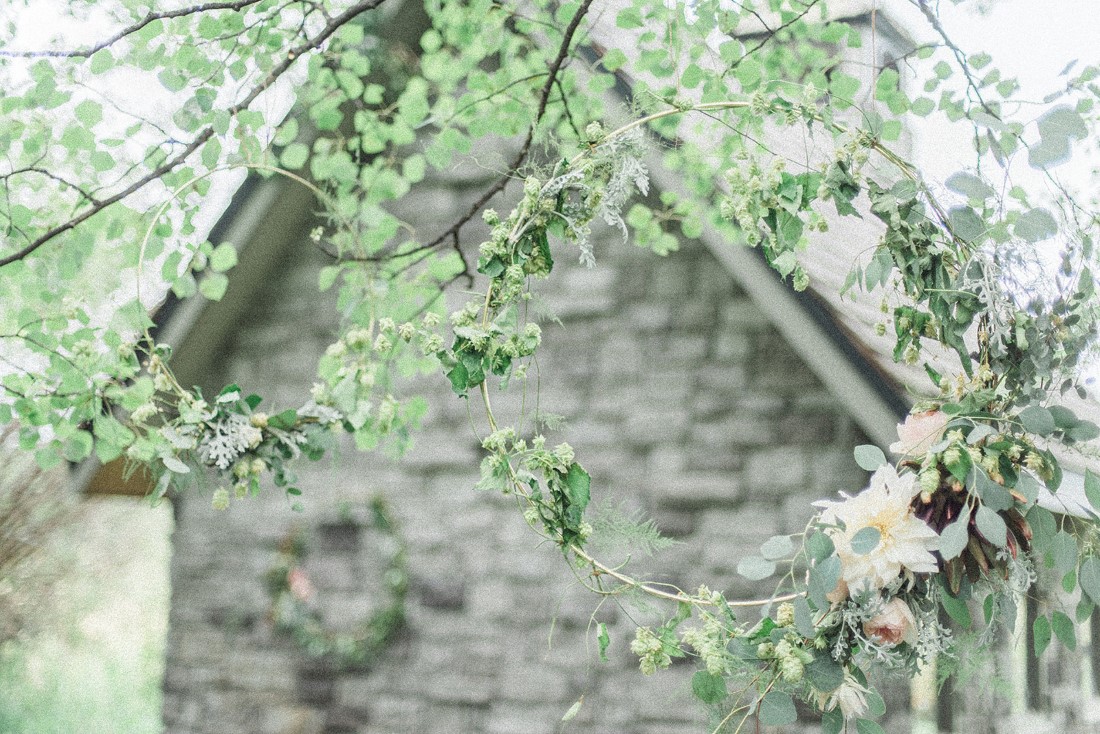 French Country Wedding antique grey barn covered in greenery