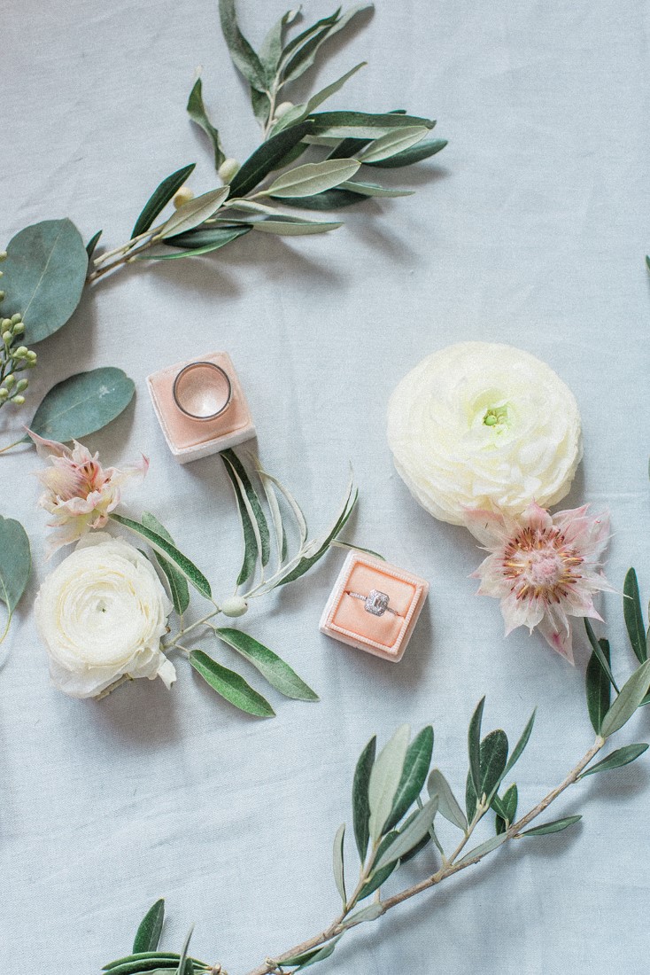 Engagement Ring in pink velvet box surrounded by white roses and greenery