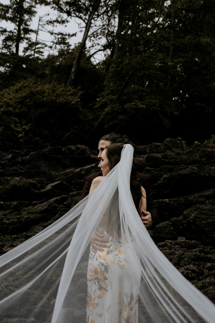 Tofino Vows bride with veil spread around her on the beach