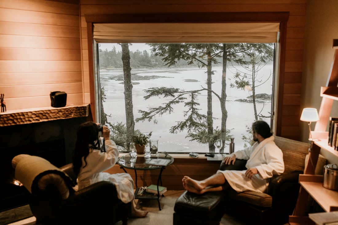 Bride and groom relax looking out at Chesterman Beach Tofino