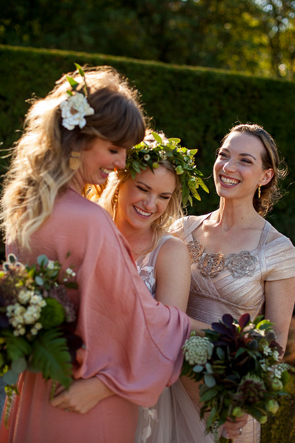 Bride and bridesmaids laugh and