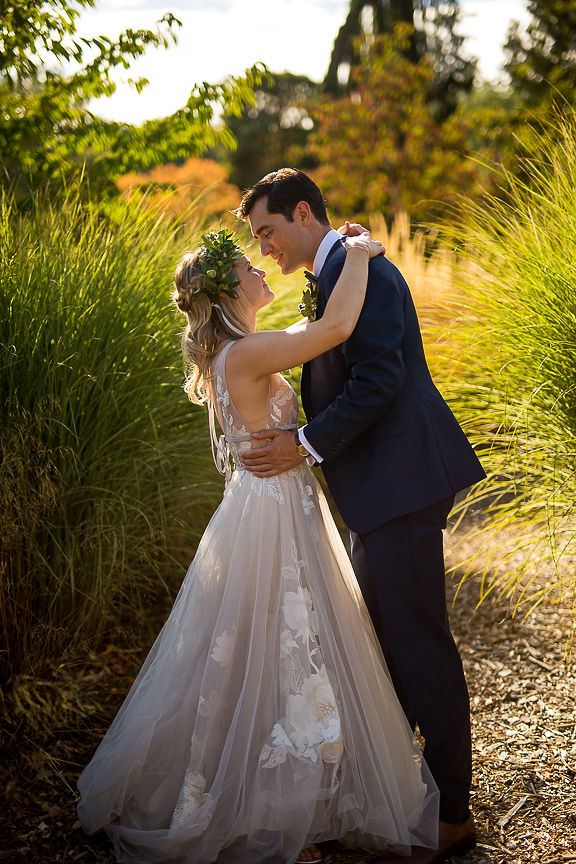 Bride and groom in tall golden grass near Vancouver