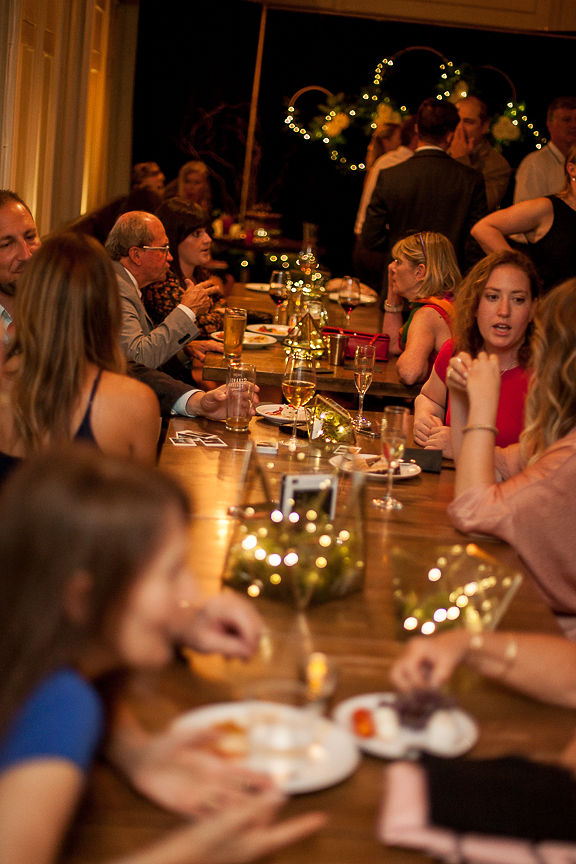 Wedding Guests sit at long table at Medina Cafe Vancouver