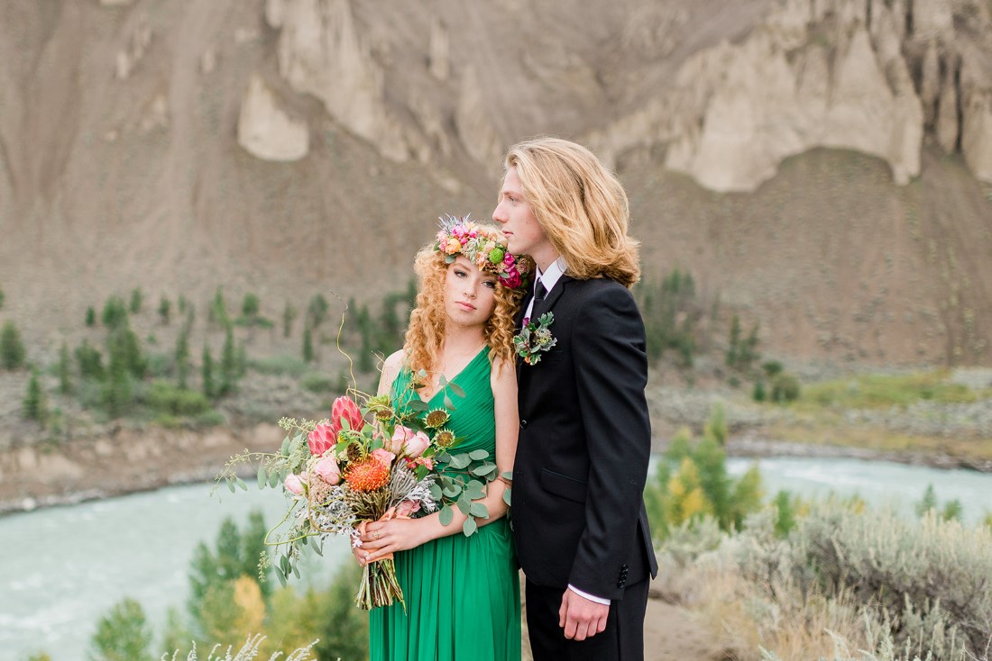 Newlyweds stand in front of BC lake