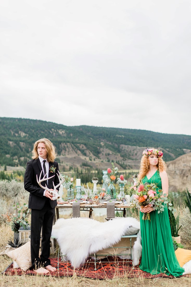 Desert Boho Inspired bridal couple look out towards the mountains