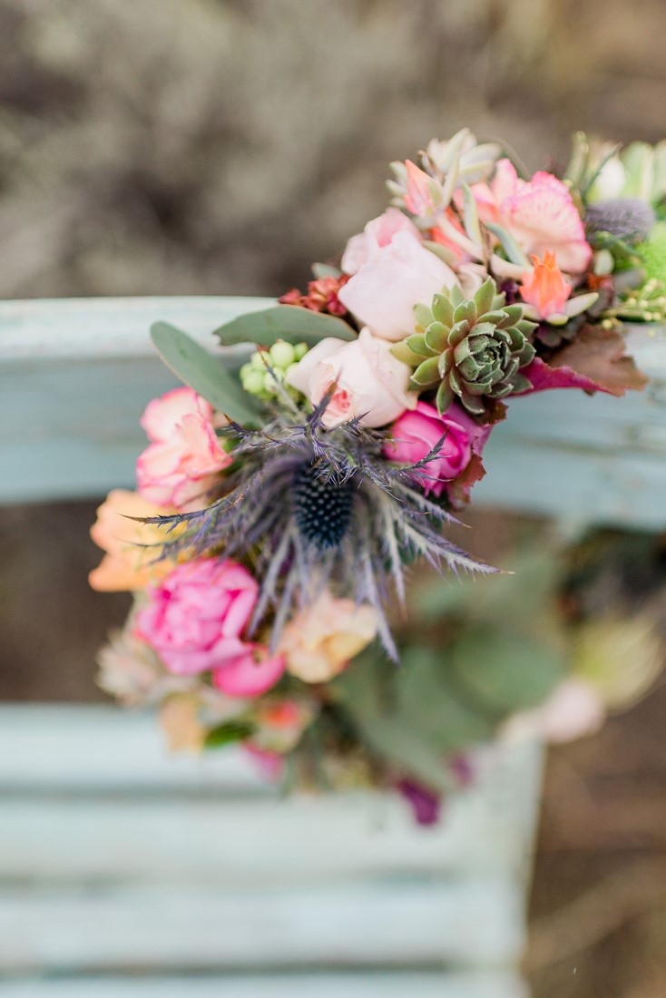 Pink, yellow, orange and red flowers on chair edge