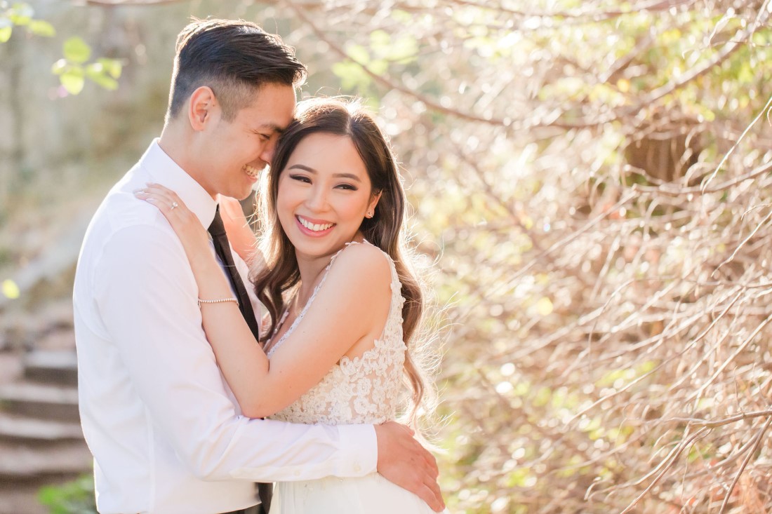 Bride to be smiles while embracing her fiance