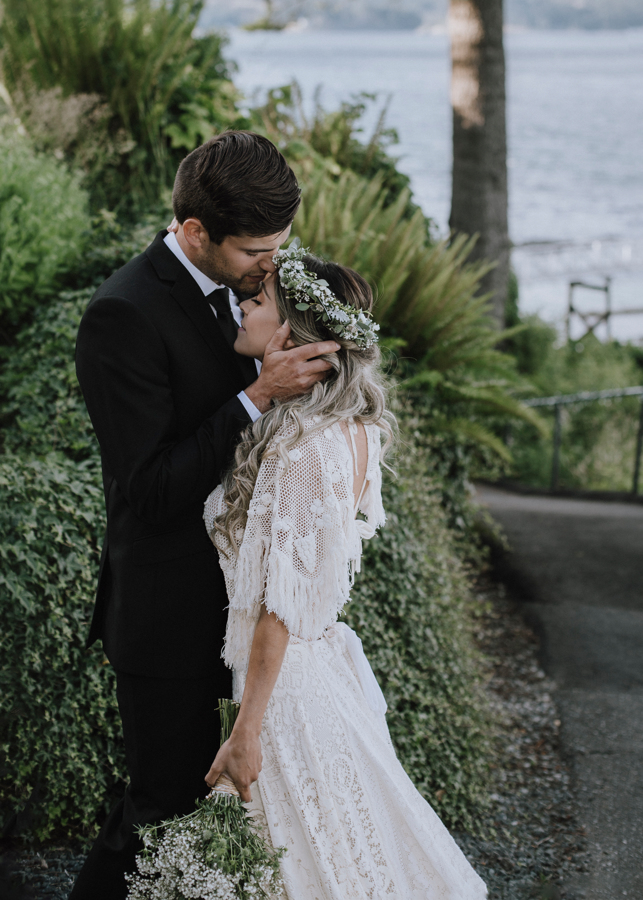 Dolphin's Resort Wedding Romance bridal couple by ocean against green wall 