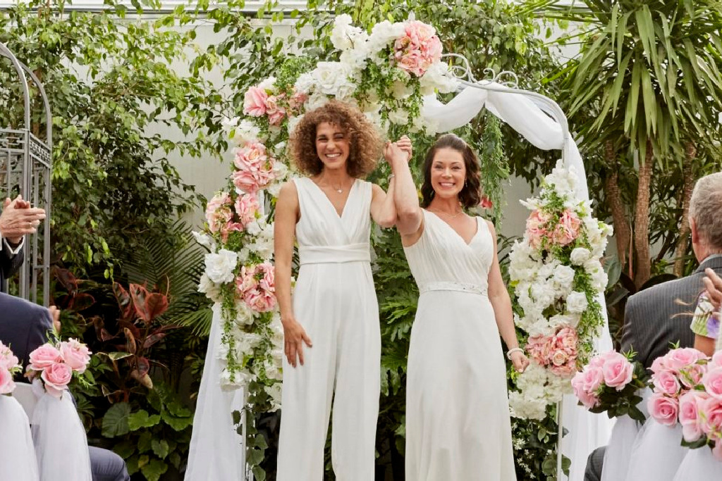 LGBTQ wedding couple hold hands after ceremony in Okanagan