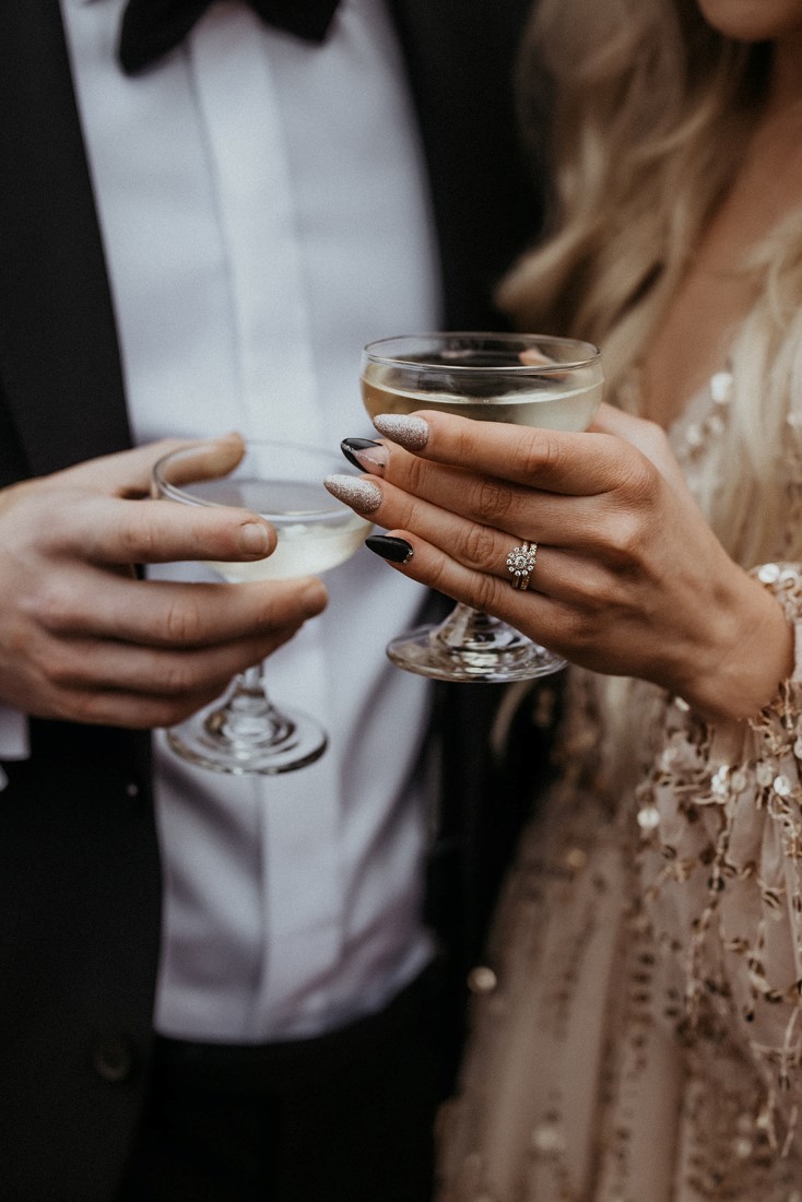 Champagne glasses held by sophisticated couple on date 