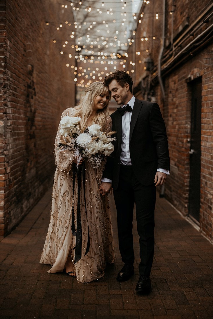 Valentine's Day stroll through Fan Tan Alley with cafe lights strung above couple 