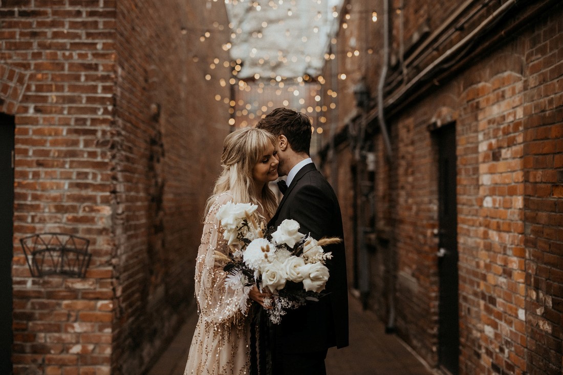 G;amorous couple in Fan Tan Alley under cafe lights on Vancouver Island