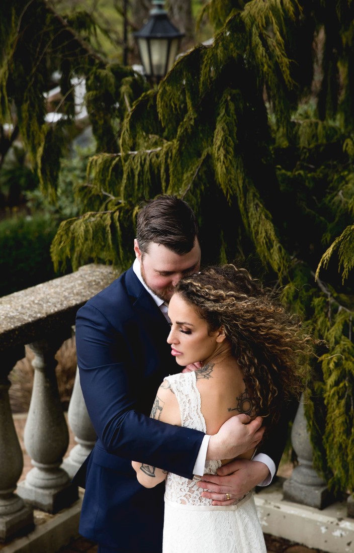 Bohemian Inspired Elopement couple embrace with bride's hair blowing in the wind