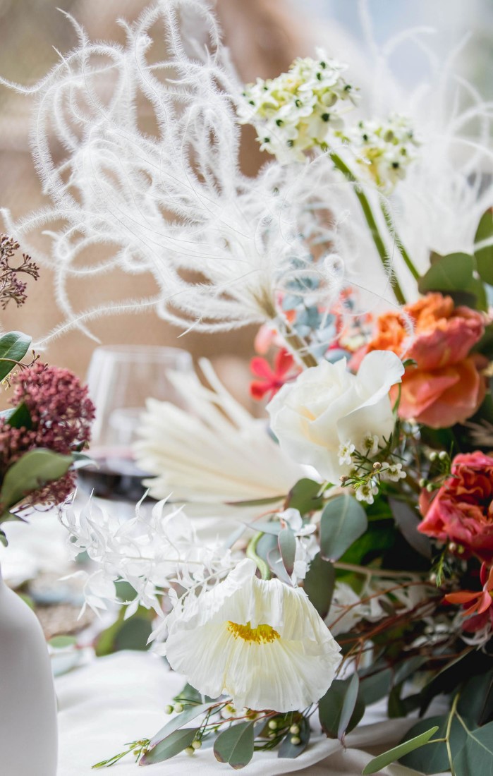 Peach, pink and white flowers on wedding sweetheart reception table