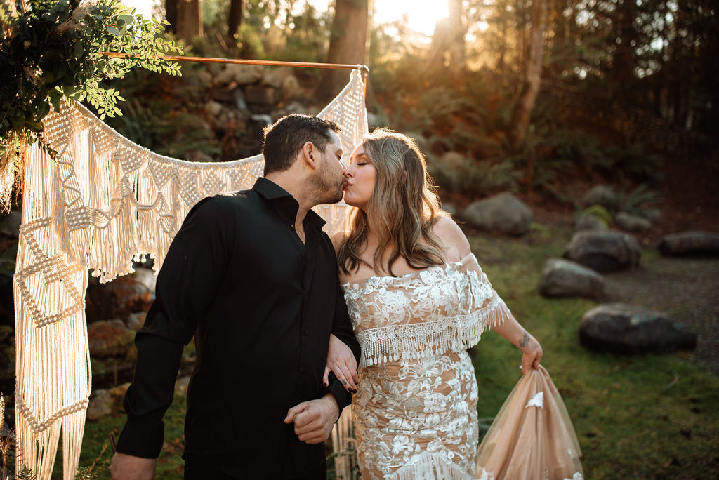 Wedding couple kiss with sunset behind them on Vancouver Island