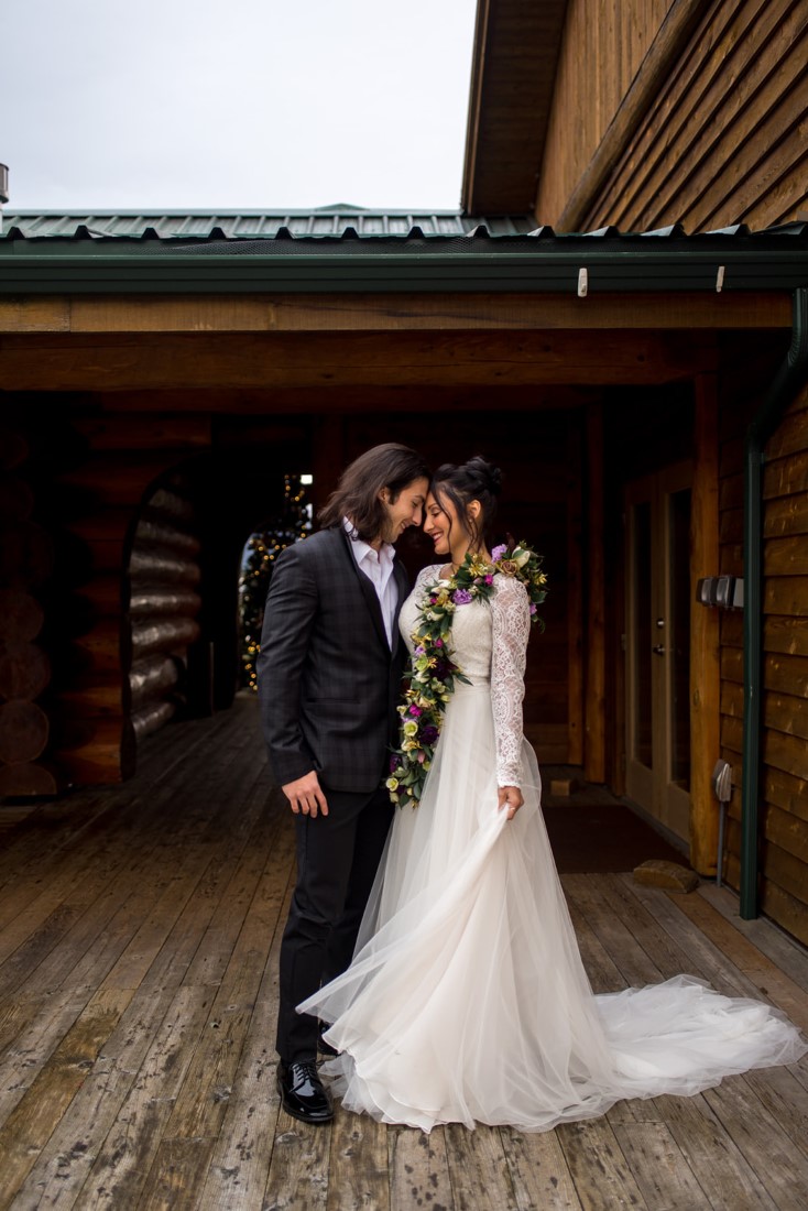 Cozy Elopement Inspiration newlyweds in front of Fraser River Lodge 