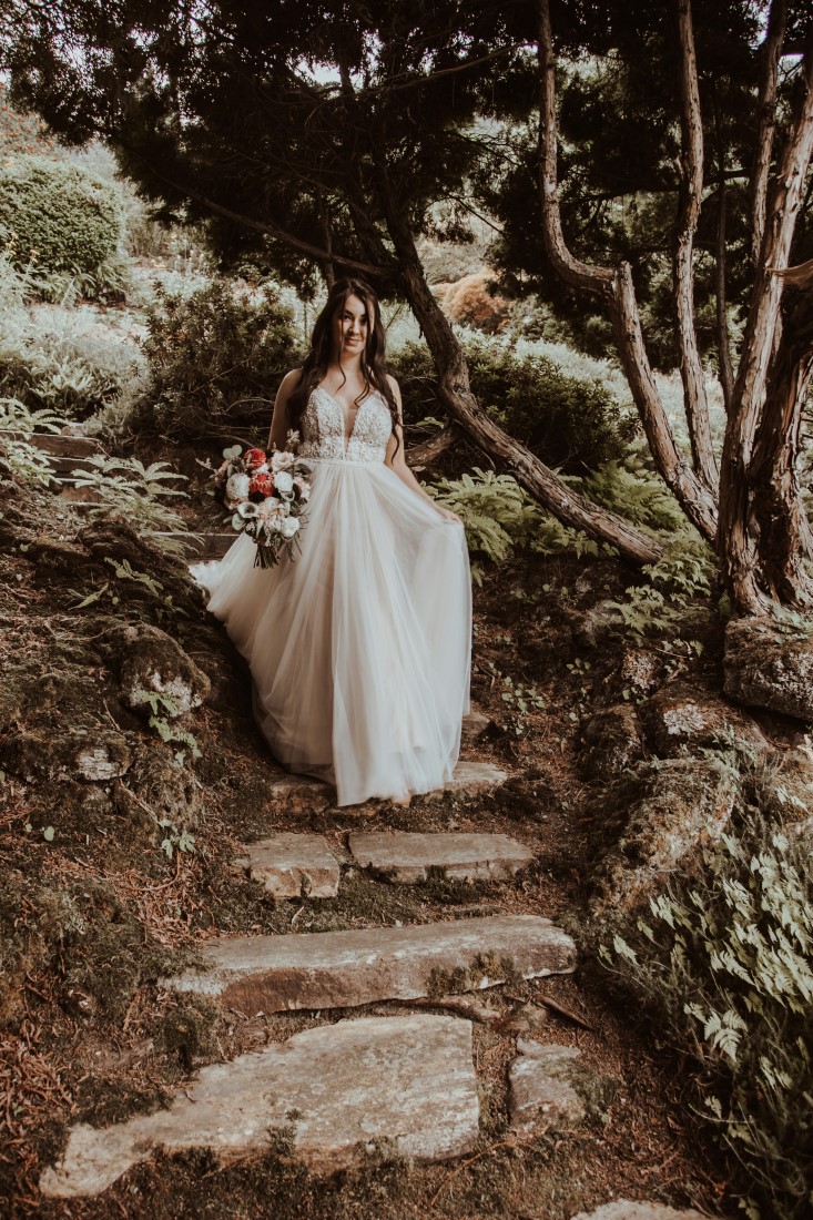 Bride comes down the path to ceremony at Blaylock Mansion