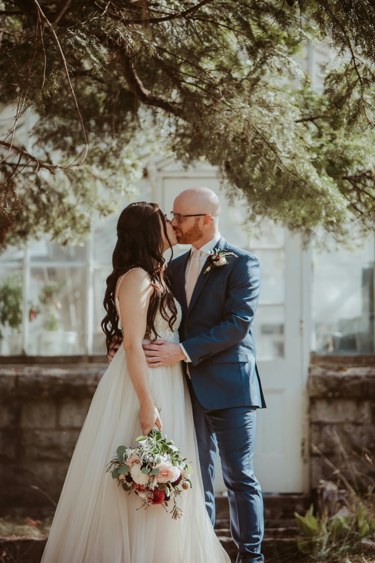 Bride and groom kiss after exchanging vows