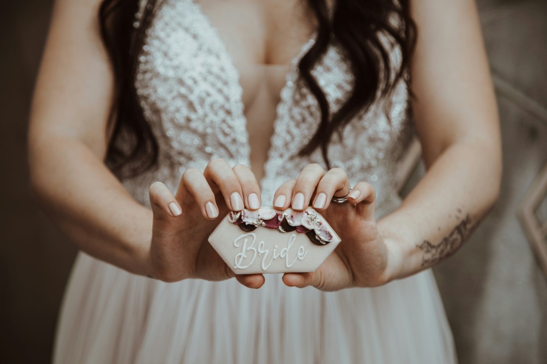 Bride holds rings in her hand