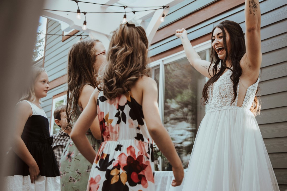 Bride greets her friends with great enthusiasm at wedding reception