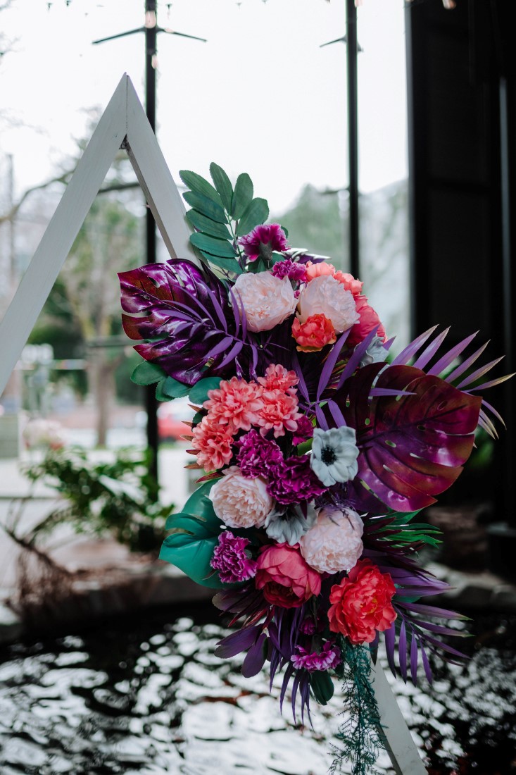 Palm leaves, anemone, peonies and carnation floral arrangement by En Vied Events